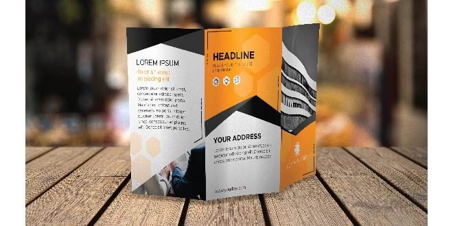 Trifold brochure mockup on tabletop Free Psd
